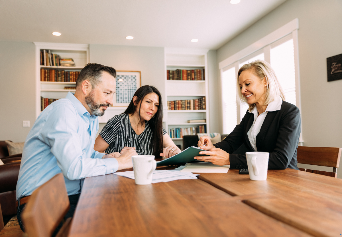 A mortgage broker is guiding a couple for investment property financing