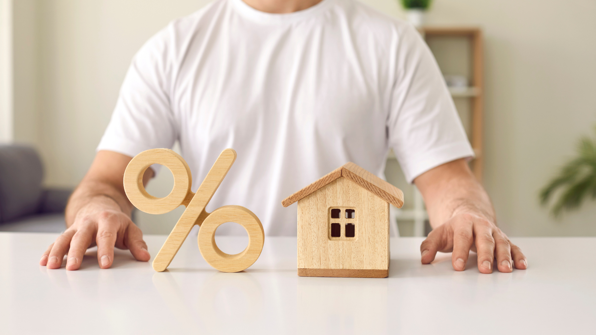 man sitting with property and percentage sign
