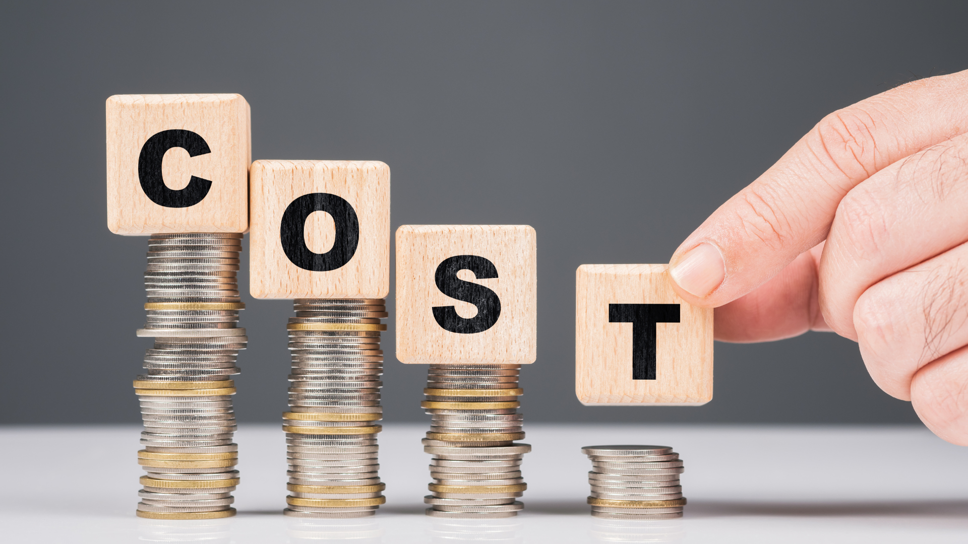 LMI for Smart Investment Properties - Image of a man demonstrating cost by coins and blocks of letters written as COST