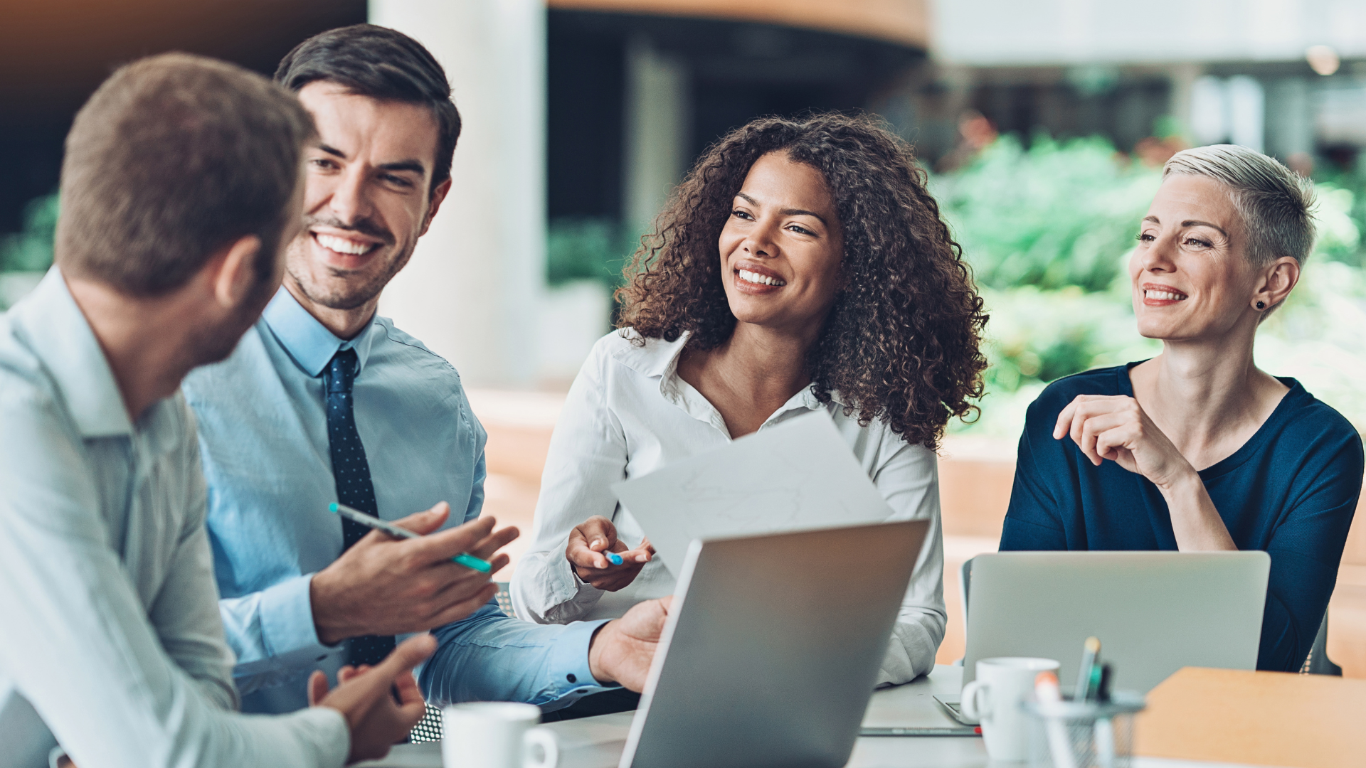 Fixing Common Misconceptions About LMI or Lenders Mortgage Insurance - Group of professionals having discussion and there are laptops on the table