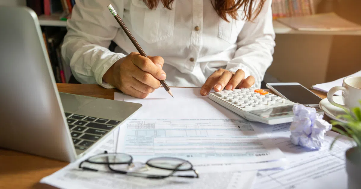 House and Land Packages - Woman is doing her budget on table 